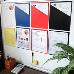 a bulletin board with several different papers on it and a calculator next to it