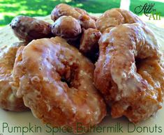 a pile of pumpkin spice buttermilk donuts on a plate with the words pumpkin spice buttermilk donuts