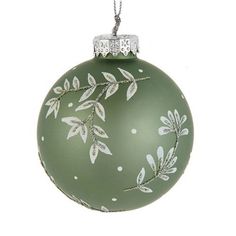 a green ornament with white flowers on it