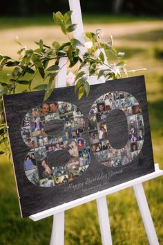 a 50th birthday sign with photos and greenery in the shape of the number 50