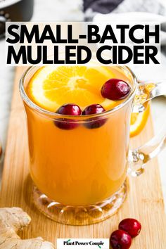 small batch mulled cider with cranberries and oranges on the side