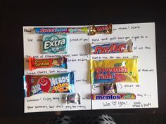 a bulletin board with candy on it in front of a whiteboard that has writing on it