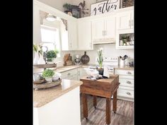 the kitchen is clean and ready to be used for cooking or baking, with white cabinets and wood flooring