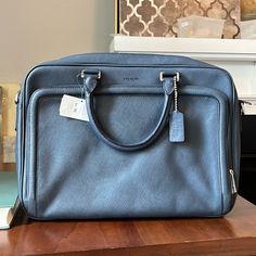 Brand New Never Used. Brought As Floor Display, Some Scratches On The Back (As Showed In Pictures) Men's Crosbycity Saffiano Briefcase F71330 Msrp Navy Leather Messenger Bag 15.8"L X 2.8"W X 11.5"H Crafted In Lightweight And Sophisticated Saffiano Leather, The Minimalist New Crosby City Brief Offers The Modern Business Man Style And Durability. The Center Front Pocket Adds Function And Dimensionality To The Design, Without Sacrificing Its Compact Profile. Color: Navy/Silver Saffiano Leather Insi Designer Epsom Leather Travel Bag, Blue Epsom Leather Rectangular Bag, Blue Rectangular Epsom Leather Bag, Rectangular Blue Epsom Leather Bag, Epsom Leather Travel Satchel, Rectangular Epsom Leather Travel Satchel, Designer Epsom Leather Satchel For Travel, Designer Epsom Leather Travel Satchel, Classic Business Satchel In Coated Canvas