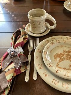 the table is set with dishes and utensils