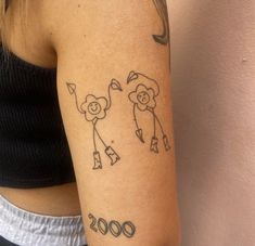 a woman with a tattoo on her arm has a drawing of two people holding umbrellas