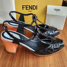 Brand New 100% Authentic Fendi Women's Sandals Featuring Block Heels In Black Color. These Fendi Chameleon Peep Toe Heel Sandals Feature Fendi Logo Script Embossed In Leather, T-Strap, Buckle Closure, And Textured Block Heel (Apprx 3"). Come With Dust Bags And Original Box. Retail $890 Made In Italy. Luxury Orange Heels For Spring, Luxury Orange Evening Sandals, Designer High Heel Orange Sandals, Designer Orange High Heel Sandals, Designer Orange Open Toe Heels, Luxury Orange Sandals For Formal Occasions, Luxury Orange Patent Leather Heels, Designer Open Heel Orange Heels, Designer Orange Sandals With Round Toe