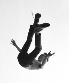 a man flying through the air while riding on top of a skateboard in front of a white background