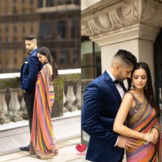 a man and woman standing next to each other in front of a building with tall buildings