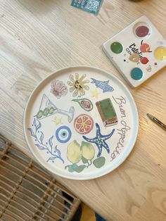 there is a plate with many different things on it next to some paintbrushes