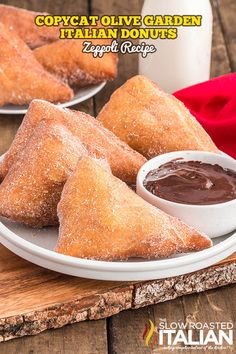 three pastries on a plate with dipping sauce in front of them and a bottle of chocolate