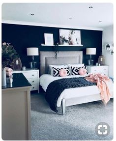 a black and white bedroom with pink accents