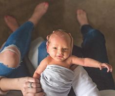 a woman holding a baby in her arms