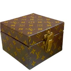 a louis vuitton box is shown with gold letters on the front and sides