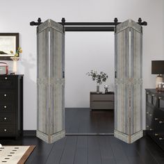 an open door leading into a bedroom with black furniture