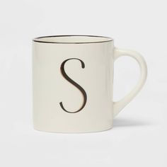 a white coffee mug with the letter s on it