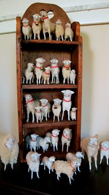 a wooden shelf filled with lots of fake sheep on top of it's sides