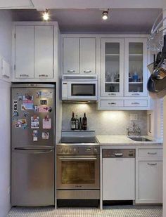 a kitchen with stainless steel appliances and white cabinets