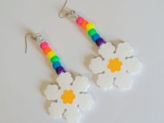 These earrings are made with rainbow pony beads and perler daisy charms. These earrings are lightweight and have fun movement. This Item is premade and is ready to ship. Perfect for any event! You will get lots of compliments in this unique wearable art! Stand out at your next event! Edm festival  Raves Party  Rave outfit  Festival outfit Pride Party favor Birthday gift Stocking stuffer Christmas gift Glow party Rave birthday  Rave gift Funky White Jewelry For Gifts, Funky White Jewelry As A Gift, Fun White Flower-shaped Jewelry, Cute White Beaded Dangle Earrings, Playful White Jewelry For Festival, Playful White Jewelry For Festivals, Playful White Festival Jewelry, Handmade Fun Beaded Earrings For Festivals, Fun White Beaded Earrings