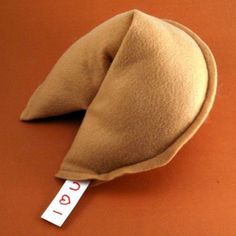 a brown hat with a white stick sticking out of it's side on an orange surface