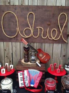 a table topped with lots of musical instruments next to a sign that says ohoh