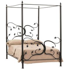 an iron bed frame with flowers on the headboard and foot board is shown in this image