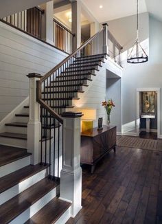 the stairs in this house are made of wood and have metal railings on them