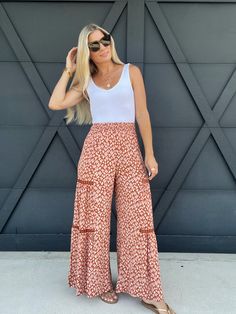 Effortlessly elevate your wardrobe with our Wide Leg Palazzo Pants in Adobe. These pants feature a flowing design that drapes elegantly on the body, providing both style and comfort, along with crotchet detailing across the sides, and a cactus pattern. Made with high quality fabric, they offer a sleek and sophisticated look that is perfect for any occasion. Waist Lying Flat: Small-11", Medium-12", Large-13" Approx. Inseam: 29" Materials: 100% Rayon Suzanne is 5'6. Size 2/4. Wearing a size small. Chic Viscose Pants For Vacation, Bohemian High-waisted Bottoms For Loungewear, High Waist Rayon Pants For Beach, High-waist Rayon Pants For Beach, Bohemian High-waisted Pants For Loungewear, Bohemian High-waisted Lounge Pants, Stretch Bohemian High-waisted Pants, Bohemian Stretch Straight Pants, Bohemian Viscose Bottoms For Spring