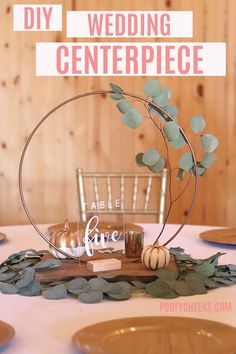 a table topped with plates covered in leaves and pumpkins next to a sign that says diy wedding centerpiece