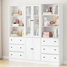 a white bookcase filled with lots of books