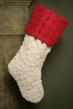 a red and white christmas stocking hanging from a wall