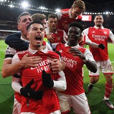 the soccer players are celebrating on the field