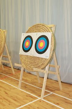 two chairs with target on them in front of a wall