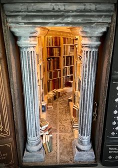 an open door to a library with books on the shelves and in between it is a row of columns