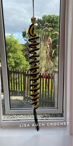 a bird feeder hanging from the side of a window