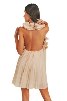 This sleeveless mini dress features a pleated design and a halter neck with a button closure. The open back is highlighted by delicate ruffle detail, and it is lined for comfort. 100% Polyester This style is sold online only. Backless Ruffle Mini Dress For Date Night, Backless Mini Dress With Ruffles For Date Night, Chic Pleated Beach Dress, Elegant Sleeveless Mini Dress With Smocked Back, Backless Ruffle Mini Dress For Cocktail, Spring Cocktail Backless Dress With Ruched Back, Elegant Backless Dress With Smocked Back For Spring, Summer Mini Dress With Pleated Back For Date Night, Chic Sleeveless Backless Dress