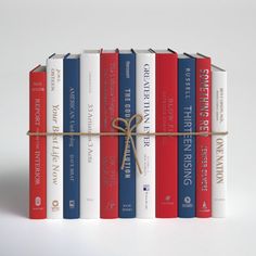 a stack of red, white and blue books tied up