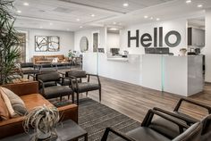 an office waiting area with chairs, couches and tables