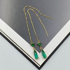 Elegant thread earrings featuring radiant emerald green crystals, intricately set to capture light from every angle. These slender drop earrings seamlessly blend classic charm with contemporary design, making them a perfect accessory for both everyday wear and special occasions. Their shimmering hue adds a touch of luxury, effortlessly elevating any ensemble. Measurements: The total length from the top of the hook to bottom - 4.13 inches (105 mm) approximately. Connector crystal: 5 mm x 5 mm Crystals: 12 mm x 4 mm These earrings would be a PERFECT GIFT for you and your family and friends!  Click here to see more Modern Everyday Earrings: https://www.etsy.com/shop/GrigorevaK?ref=seller-platform-mcnav§ion_id=27174357 Thank you for your visit! Emerald Green Thread Earrings, Green Teardrop Ear Elegant Green Long Drop Earrings, Elegant Green Teardrop Earring (single), Green Crystal Earrings For Pierced Ears, Elegant Green Crystal Earrings For Pierced Ears, Elegant Green Teardrop Single Earring, Green Teardrop Crystal Earrings Pierced, Single Green Long Drop Earring, Green Single Long Drop Earring, Green Crystal Drop Earrings For Gift