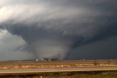 a large tornado is seen in the distance