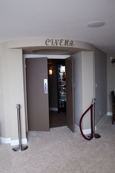 an empty room with two elevators and a sign on the wall