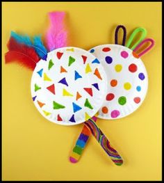 two paper plates with colorful feathers on them