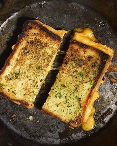 two grilled cheese sandwiches sitting on top of a frying pan