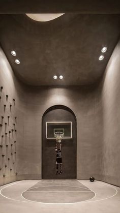 a basketball court in the middle of a room with a person standing on one side