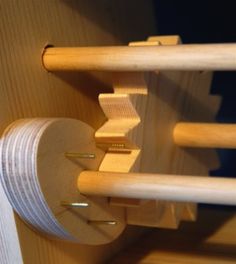 a close up of a wooden rack with several pieces of wood attached to the wall