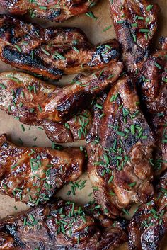 grilled steaks with herbs and seasoning on a cutting board