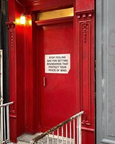 a red door with a sign on it