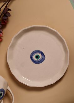 a white plate with an evil eye painted on it