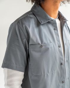 Gray Button-up Tops With Pockets, Gray Shirt With Pockets For Work, Cotton Utility Shirt With Camp Collar, Fitted Streetwear Shirt With Pockets, Fitted Shirt With Pockets For Streetwear, Solid Utility Top With Button Closure, Relaxed Fit Utility Button-up Tops, Utility Tops With Relaxed Fit, Utility Workwear Tops With Side Pockets