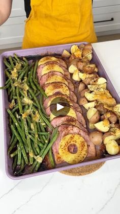 a pan filled with green beans, potatoes and ham